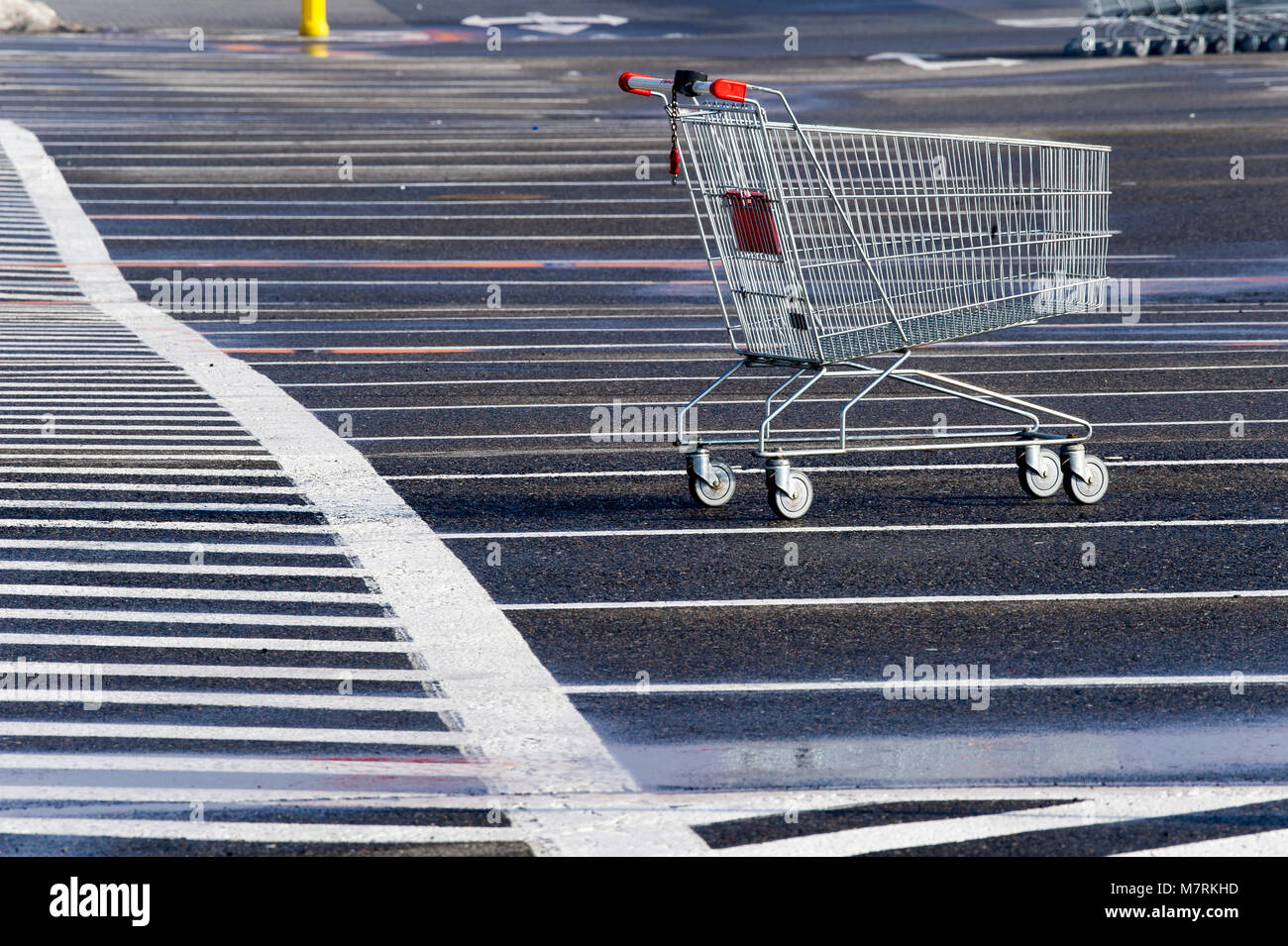 Parked shopping carts equipped with coinoperated locking mechanisms in