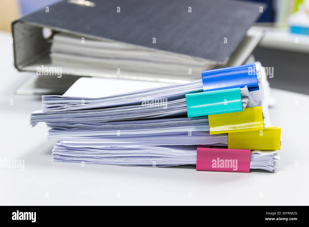 Stack of papers documents in archives files with paper clips on desk at ...