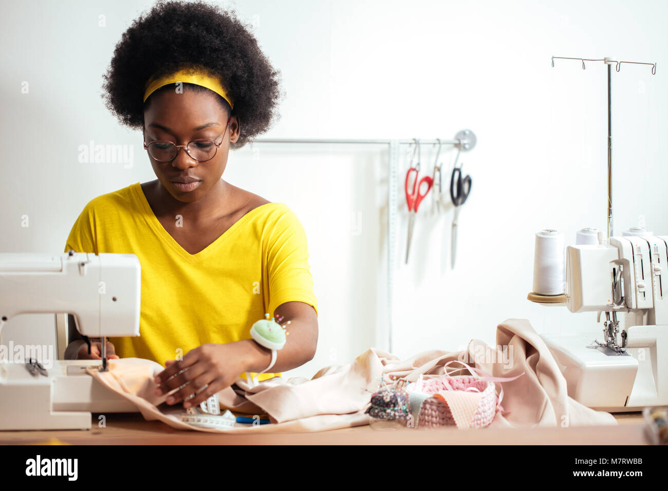 african seamstress sews clothes 