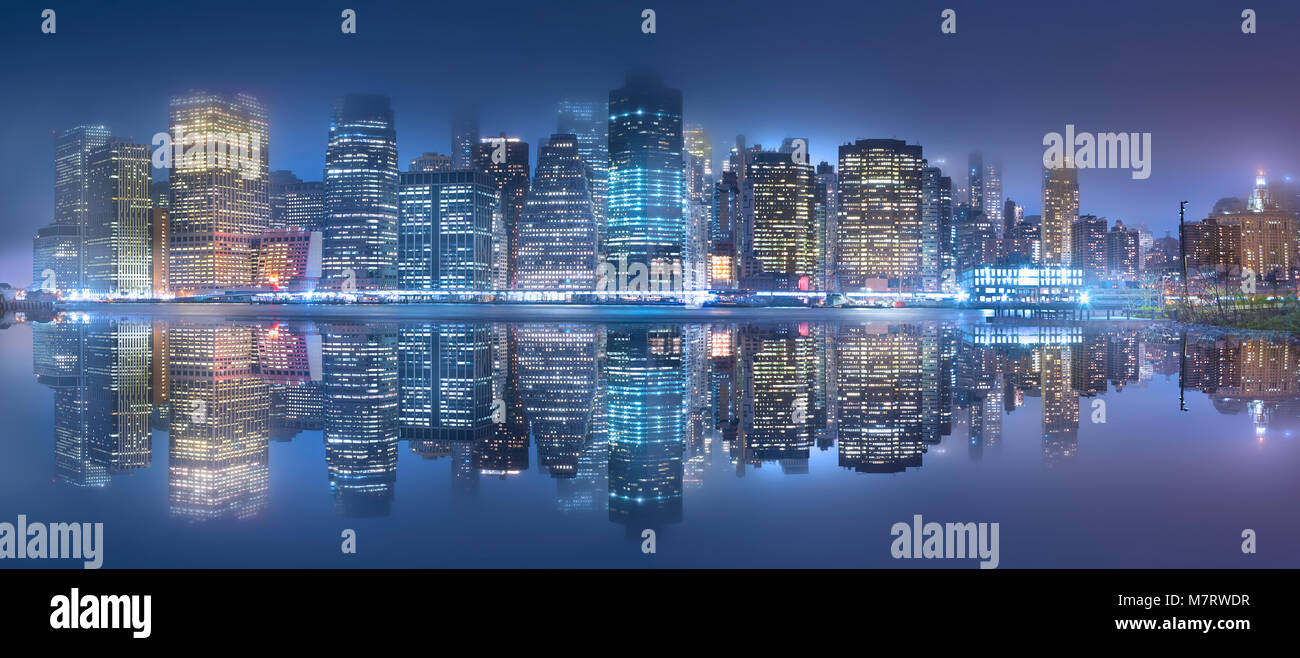 The New York City skyline at night. Photographed from across the East ...