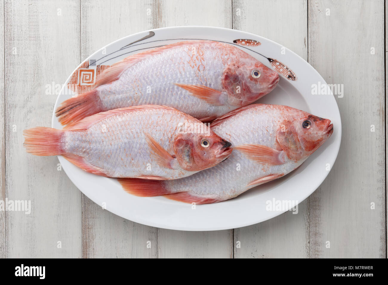 Peeled red tilapia in dish plate Stock Photo