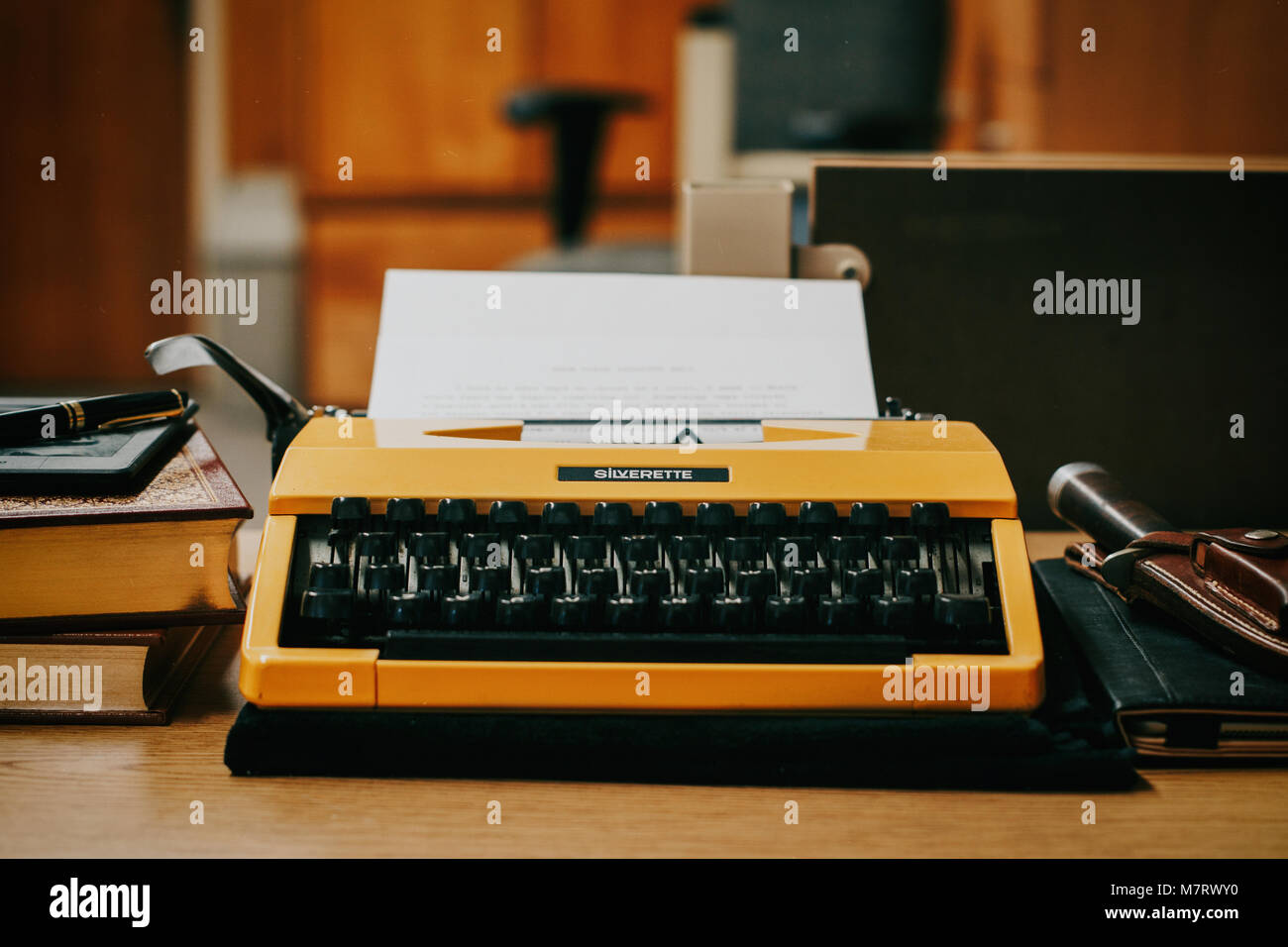Yellow Typewriter on Desk Stock Photo