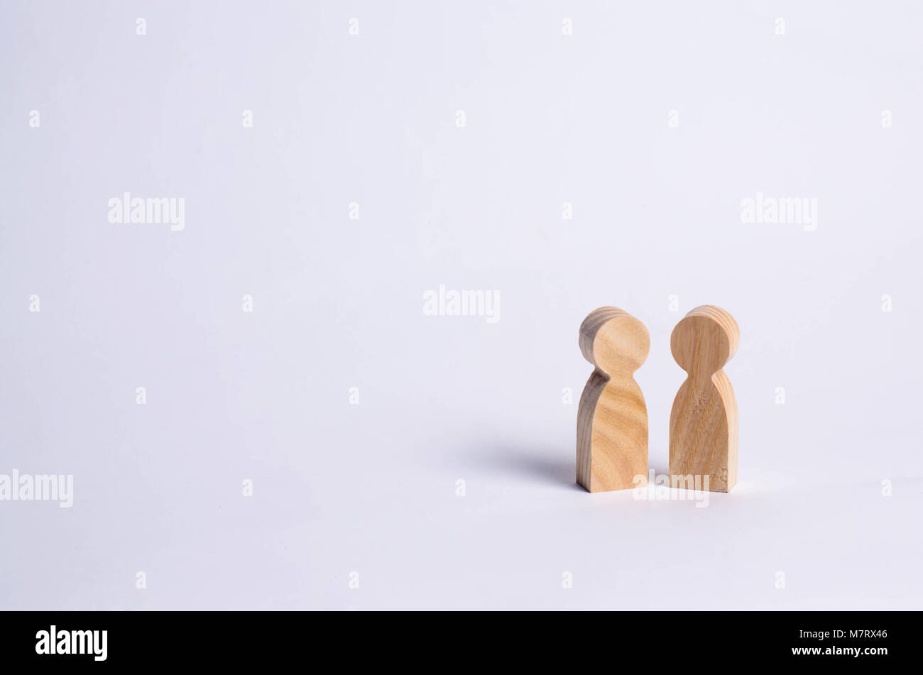 wooden human figures stand together. Social concept, family, team, friends, brothers and sisters. Space for text. Stock Photo