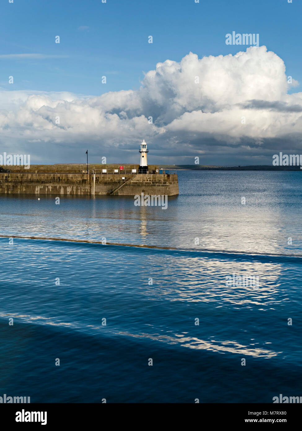 Evening light on Smeatons Pier and old lighthouse at high tide, St. Ives harbour, Cornwall, England, UK Stock Photo