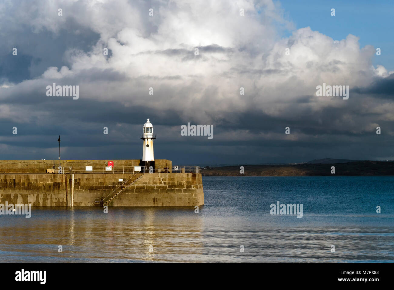 Evening light on Smeatons Pier and old lighthouse at high tide, St. Ives harbour, Cornwall, England, UK Stock Photo