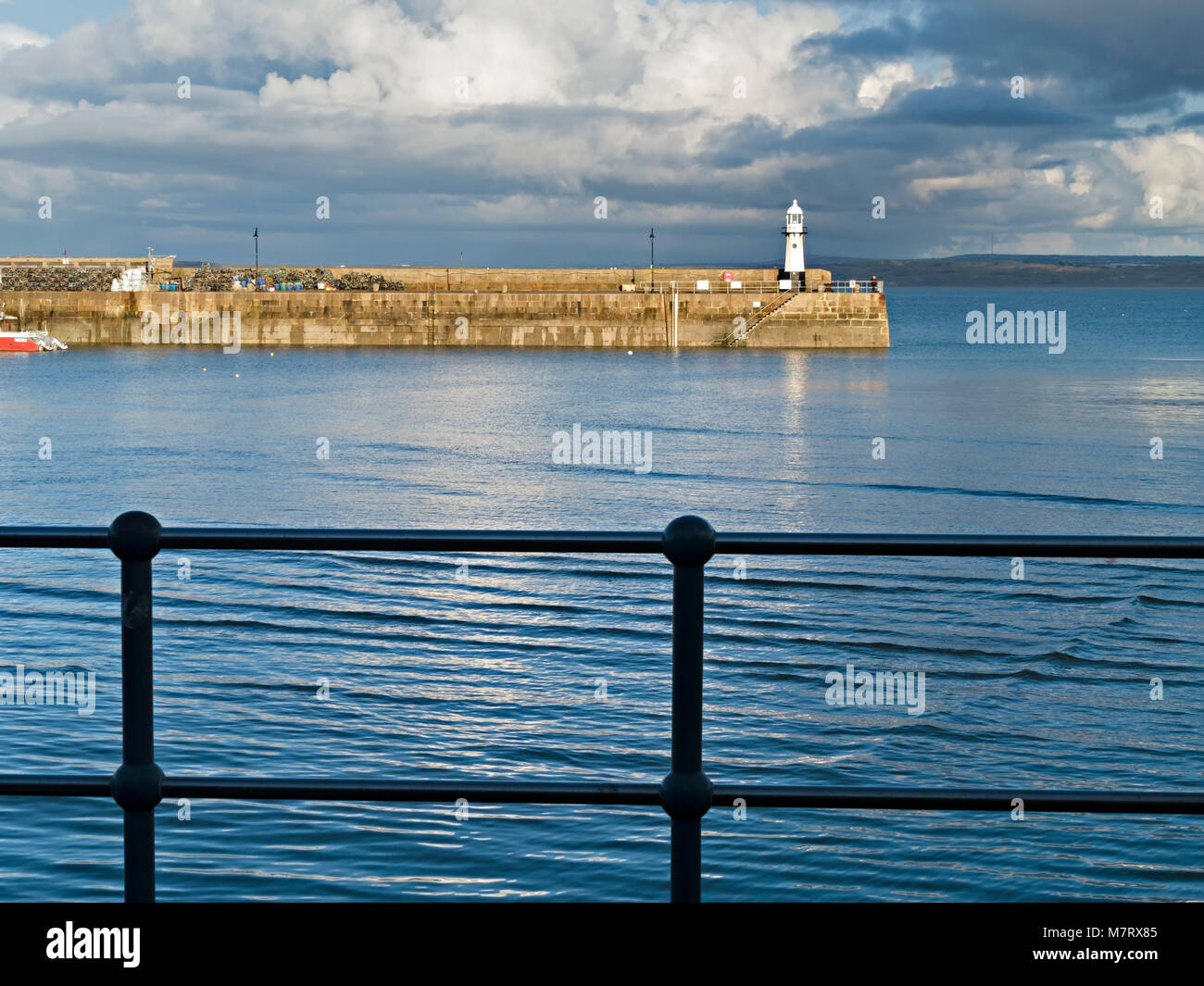 Evening light on Smeatons Pier and old lighthouse at high tide, St. Ives harbour, Cornwall, England, UK Stock Photo