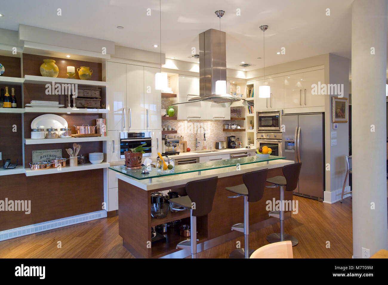 Brown wooden kitchen with island with a granite counter top Stock Photo
