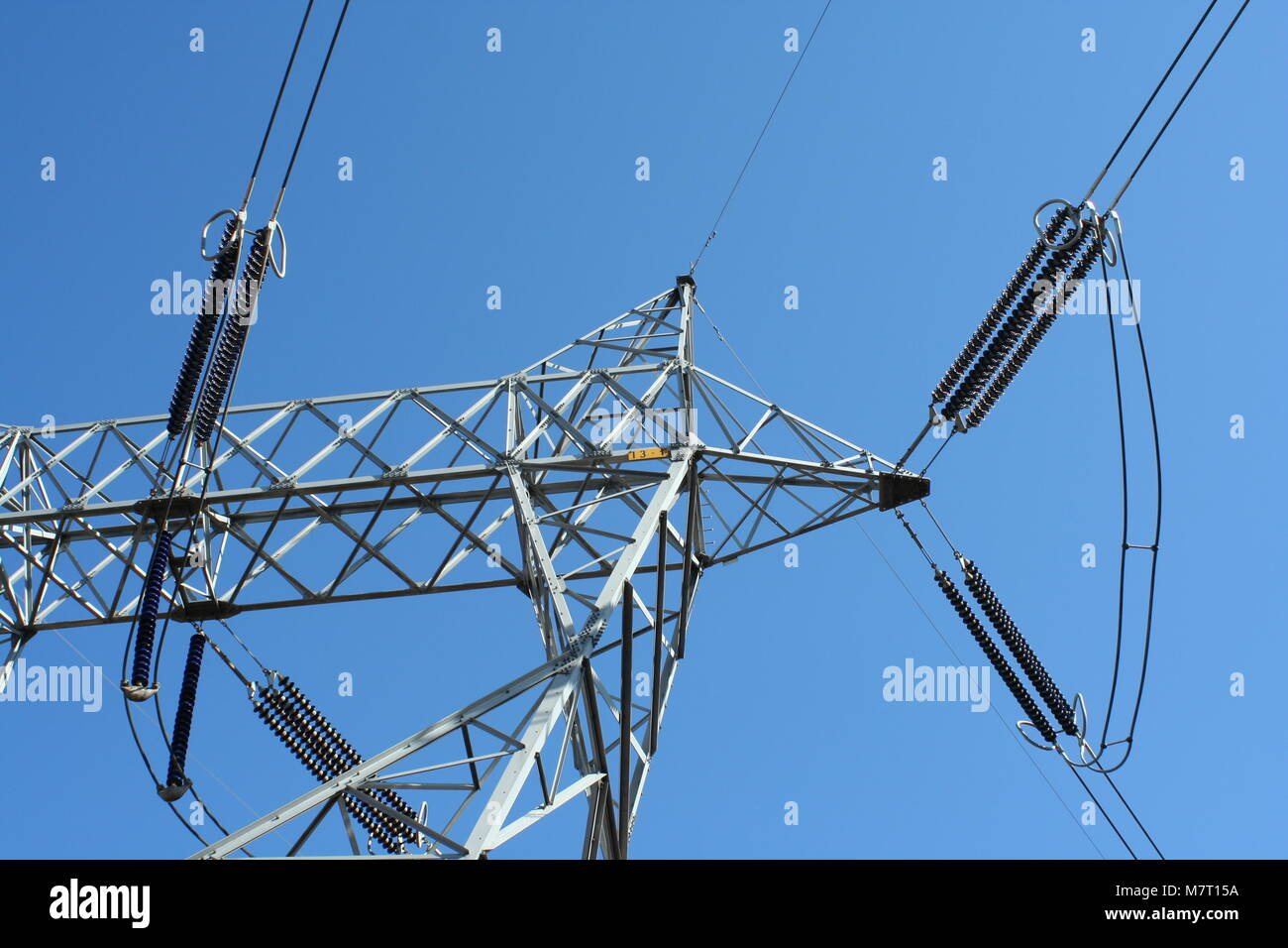 Power line tower against blue sky Stock Photo - Alamy