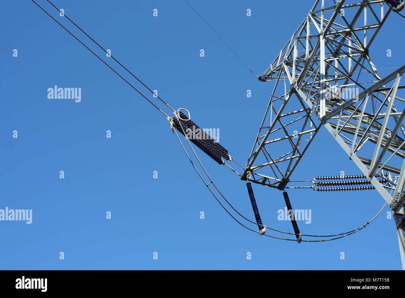 Power line tower against blue sky Stock Photo - Alamy