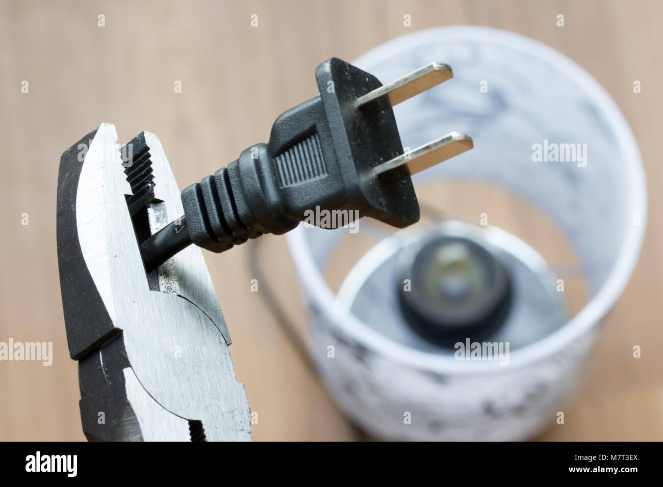 Repair of electrical cable. The pliers cut the power cord, close up