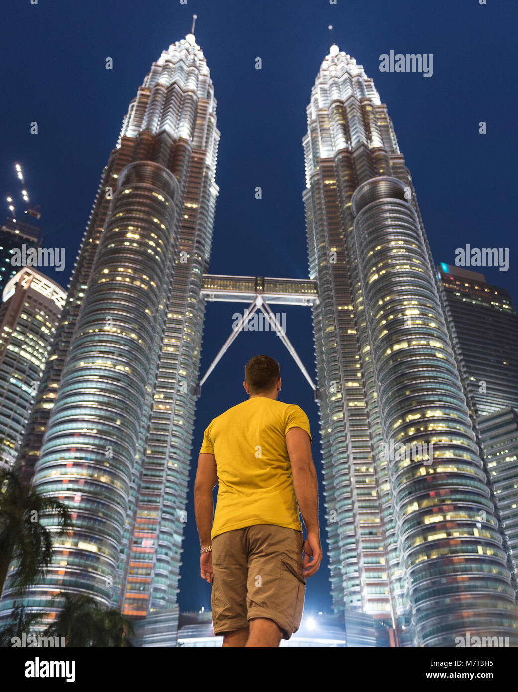 man at the petronas towers in kuala lumpur by night Stock Photo