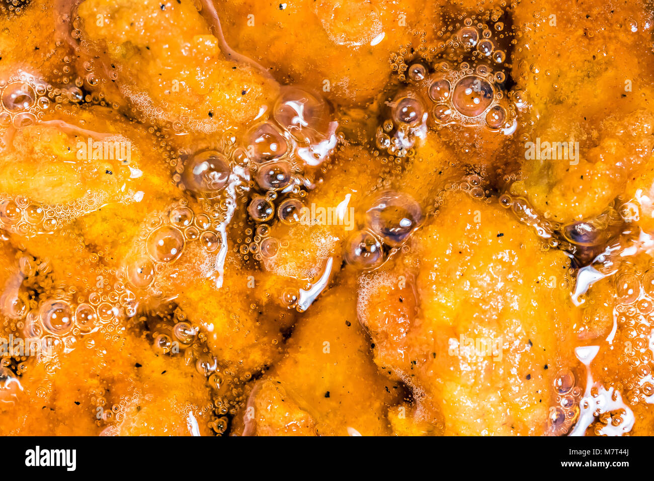 Frying the meat wrapped in breadcrumb on the pan, close up. Fried chicken in oil Stock Photo Alamy