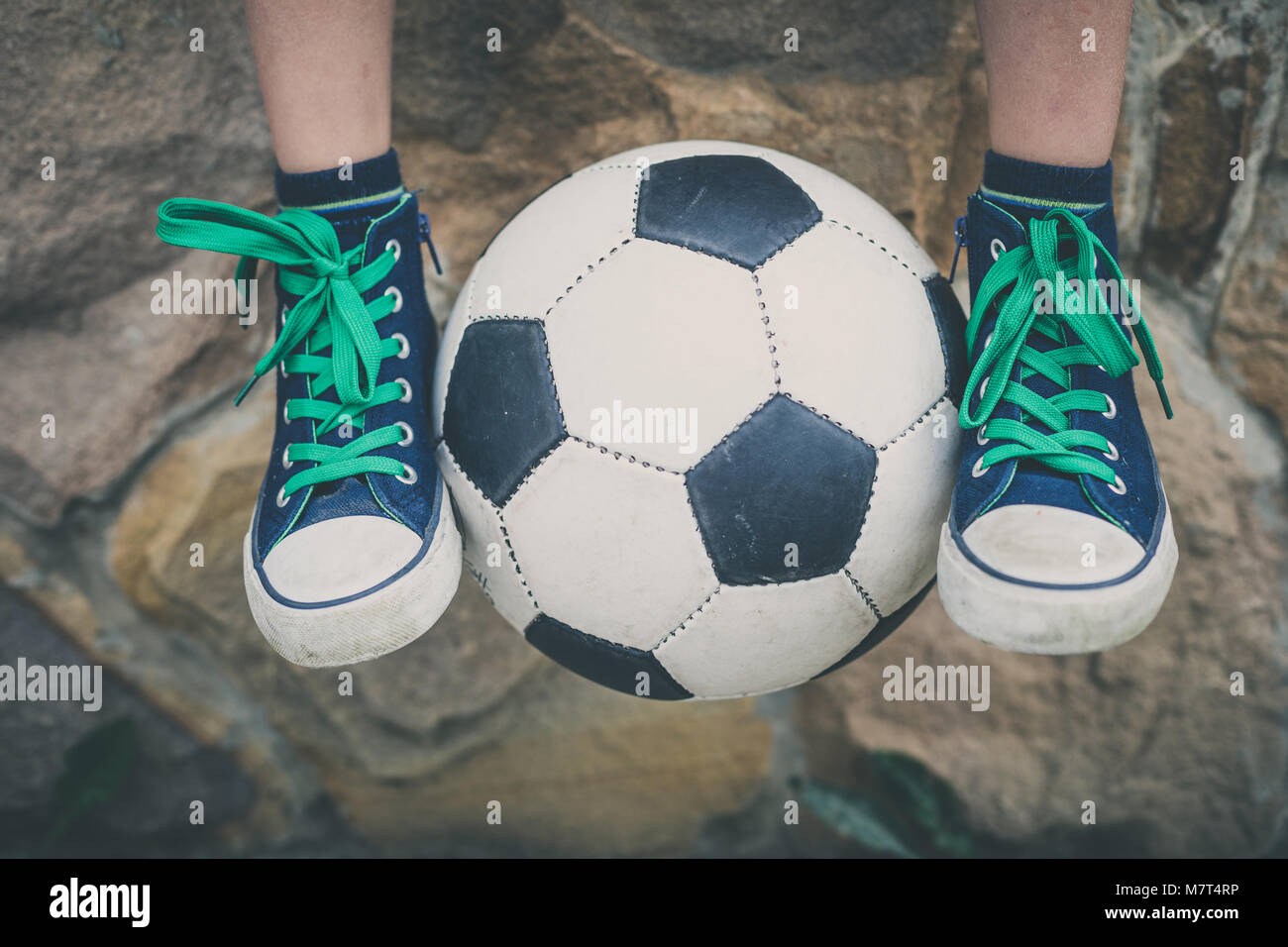 Young little boy sitting  with soccer ball. Concept of sport. Stock Photo
