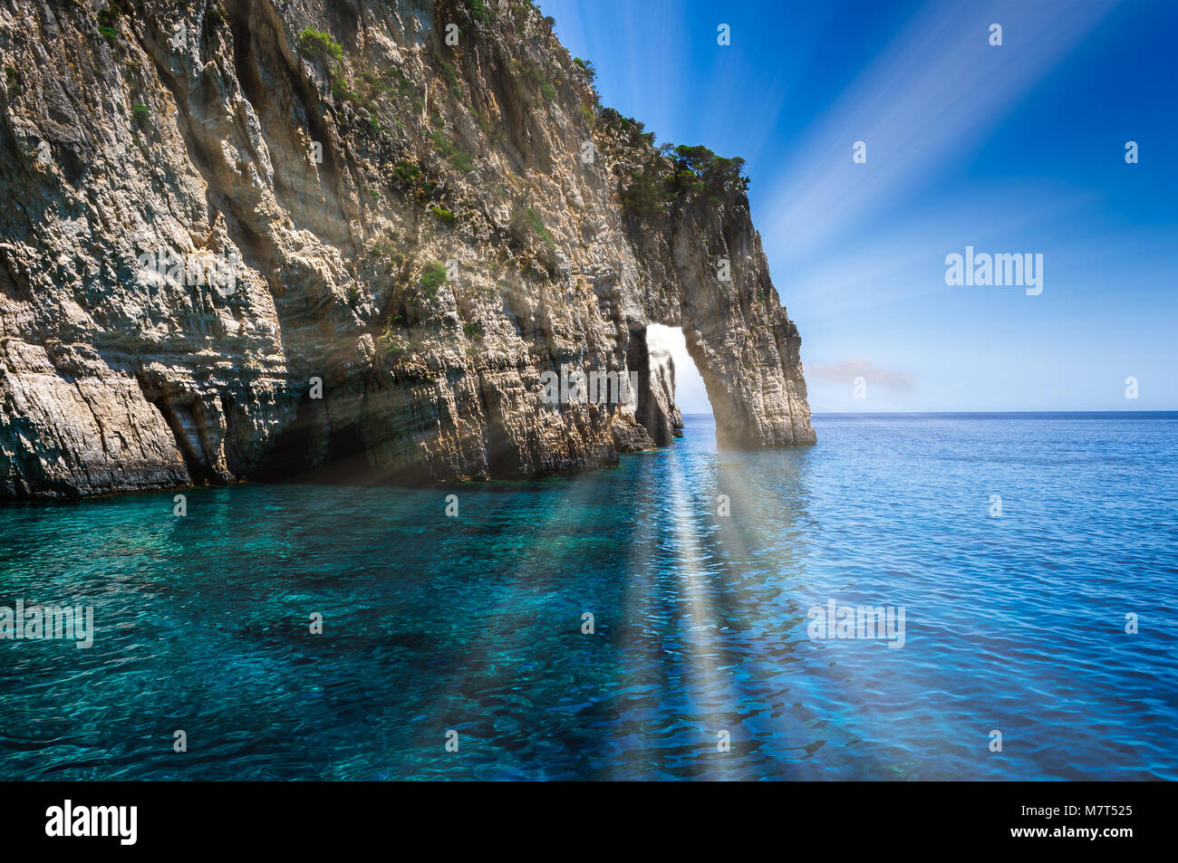 Sun going through Blue caves on Zakynthos island, Greece Stock Photo