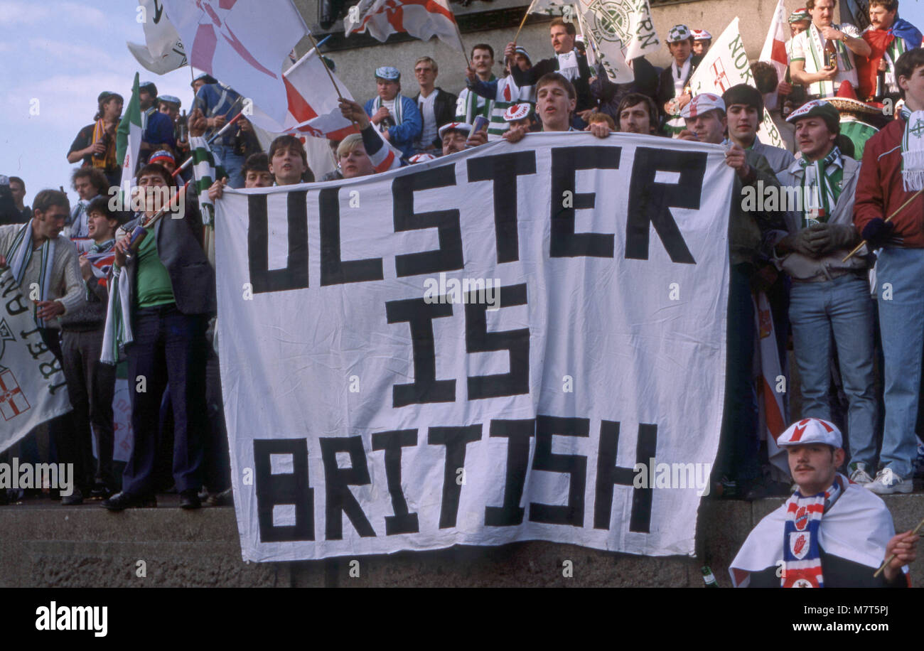 Ulster football fans in Trafalgar Square after a win with flags and a banner reading Ulster is British Stock Photo