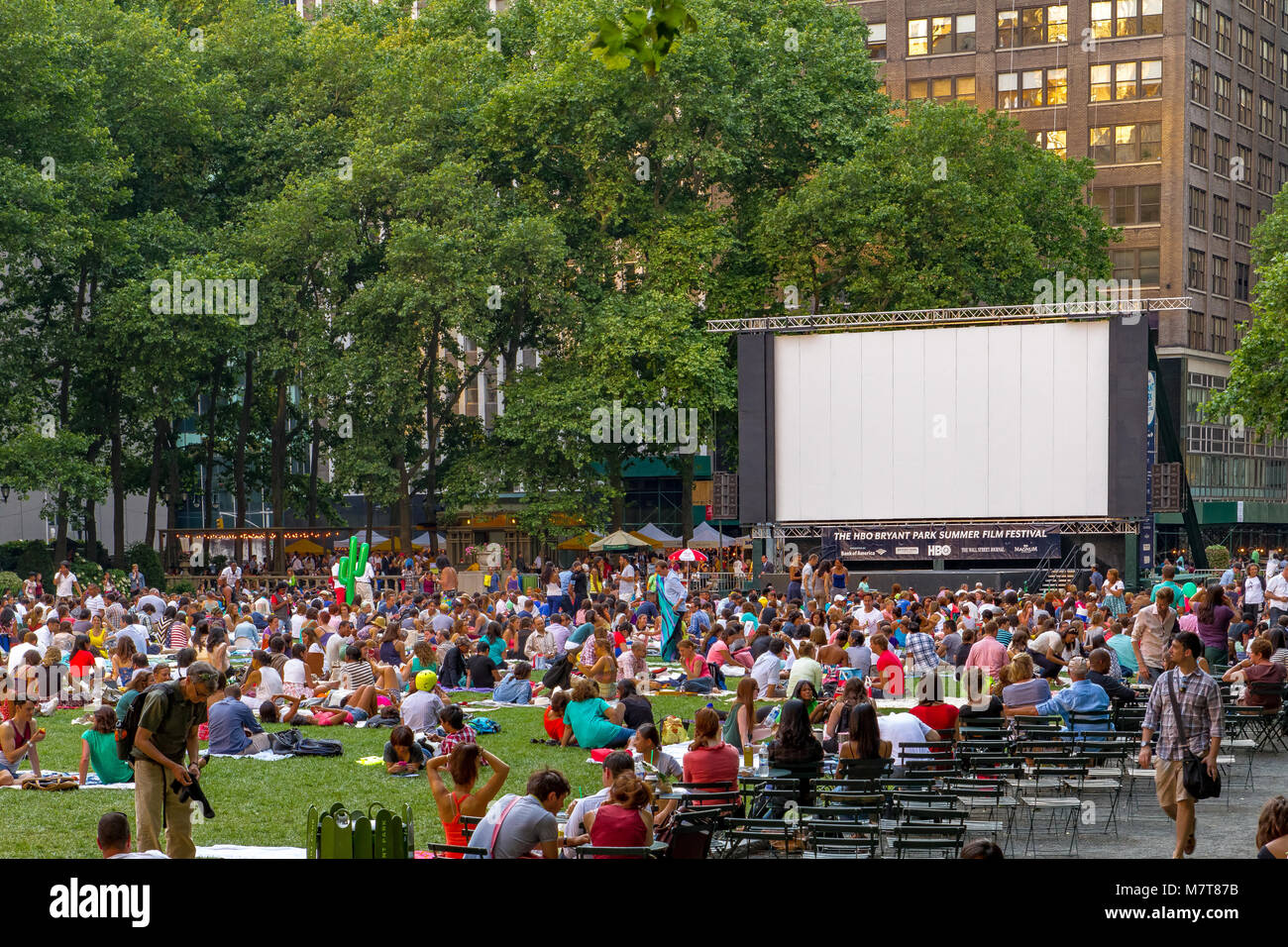 Crowds gathered on the the lawn at Bryant Park, Manhattan for the outdoor Bryant Park Film Festival ,an outdoor film screening event in New York City Stock Photo