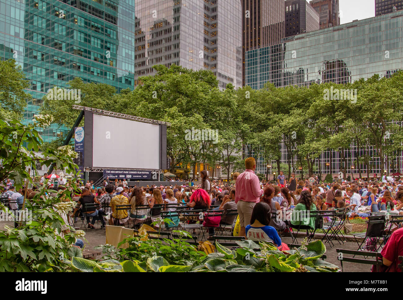 Crowds gathered on the the lawn at Bryant Park, Manhattan for the outdoor Bryant Park Film Festival ,an outdoor film screening event in New York City Stock Photo