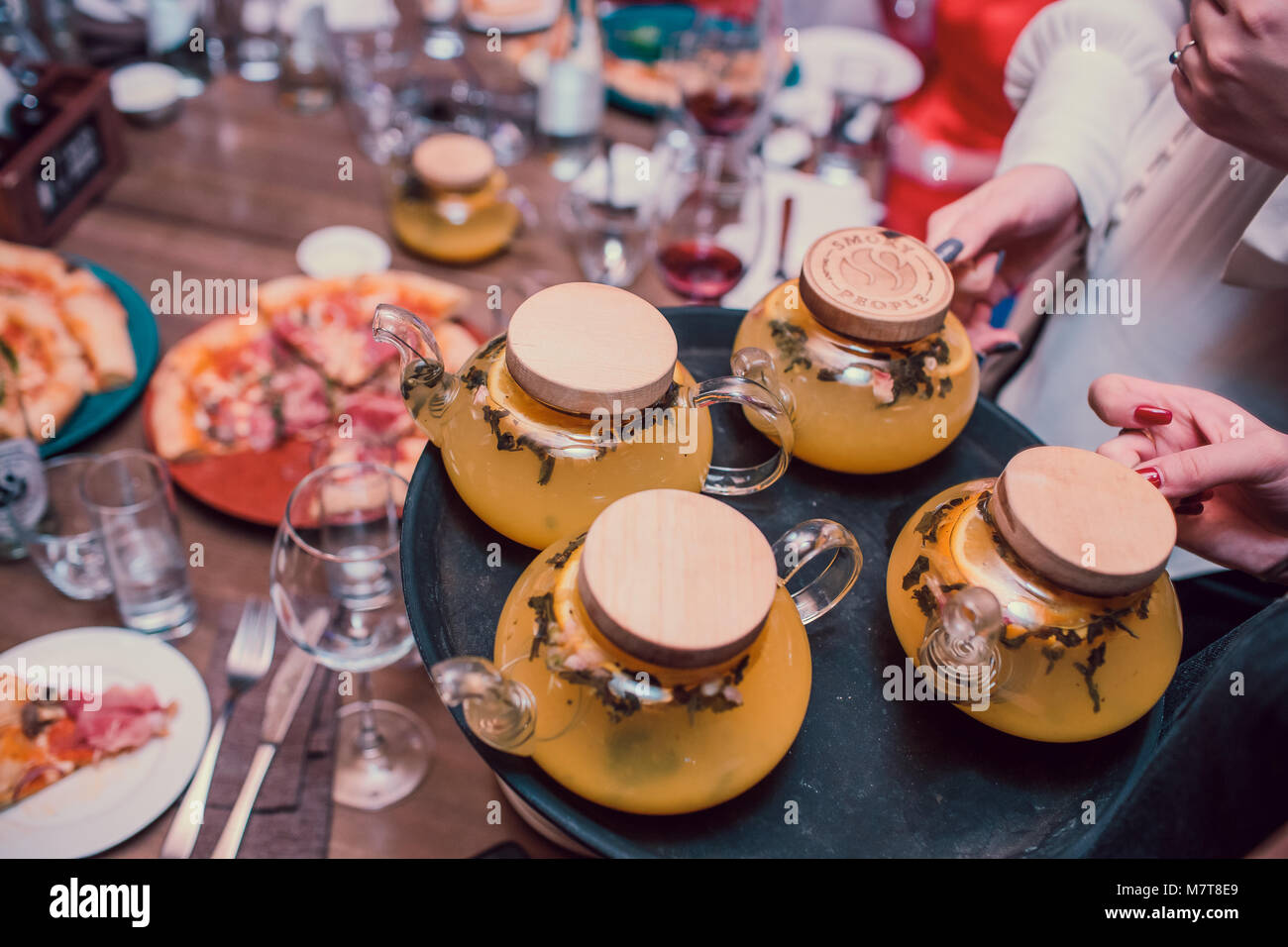 The waitress is carrying tea. Hospitable girl waitress holding tray