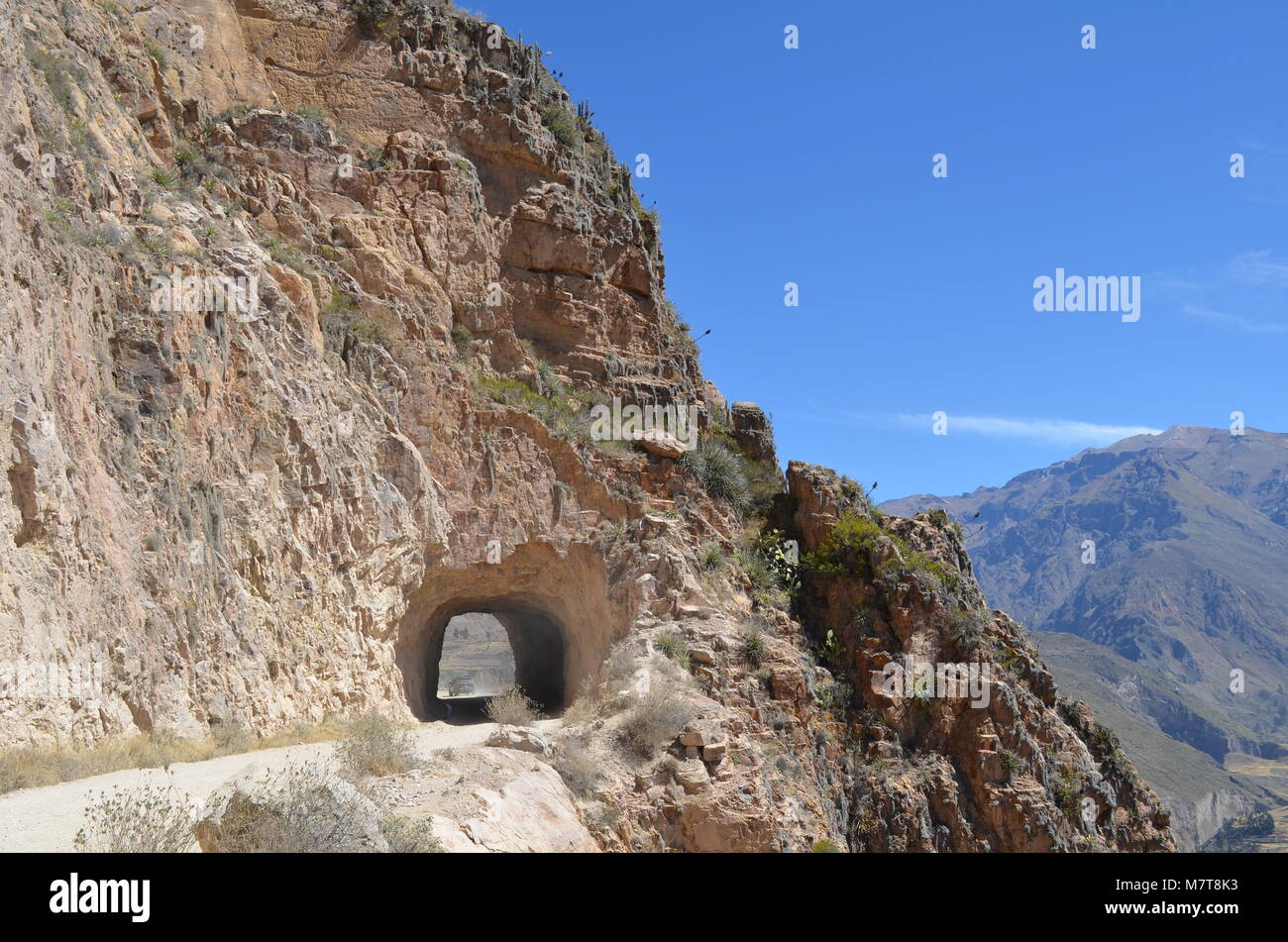 Mountain road through the tunnel. Highway in a mountainous area near the  rocky slopes of stone, Peru Stock Photo - Alamy