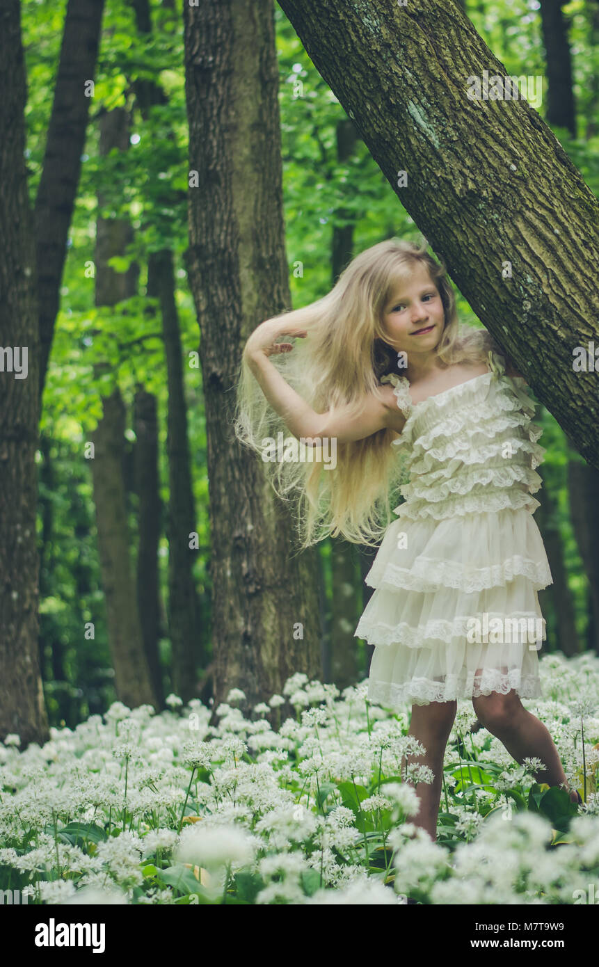 beautiful girl fairy with long blond hair in spring forest Stock Photo