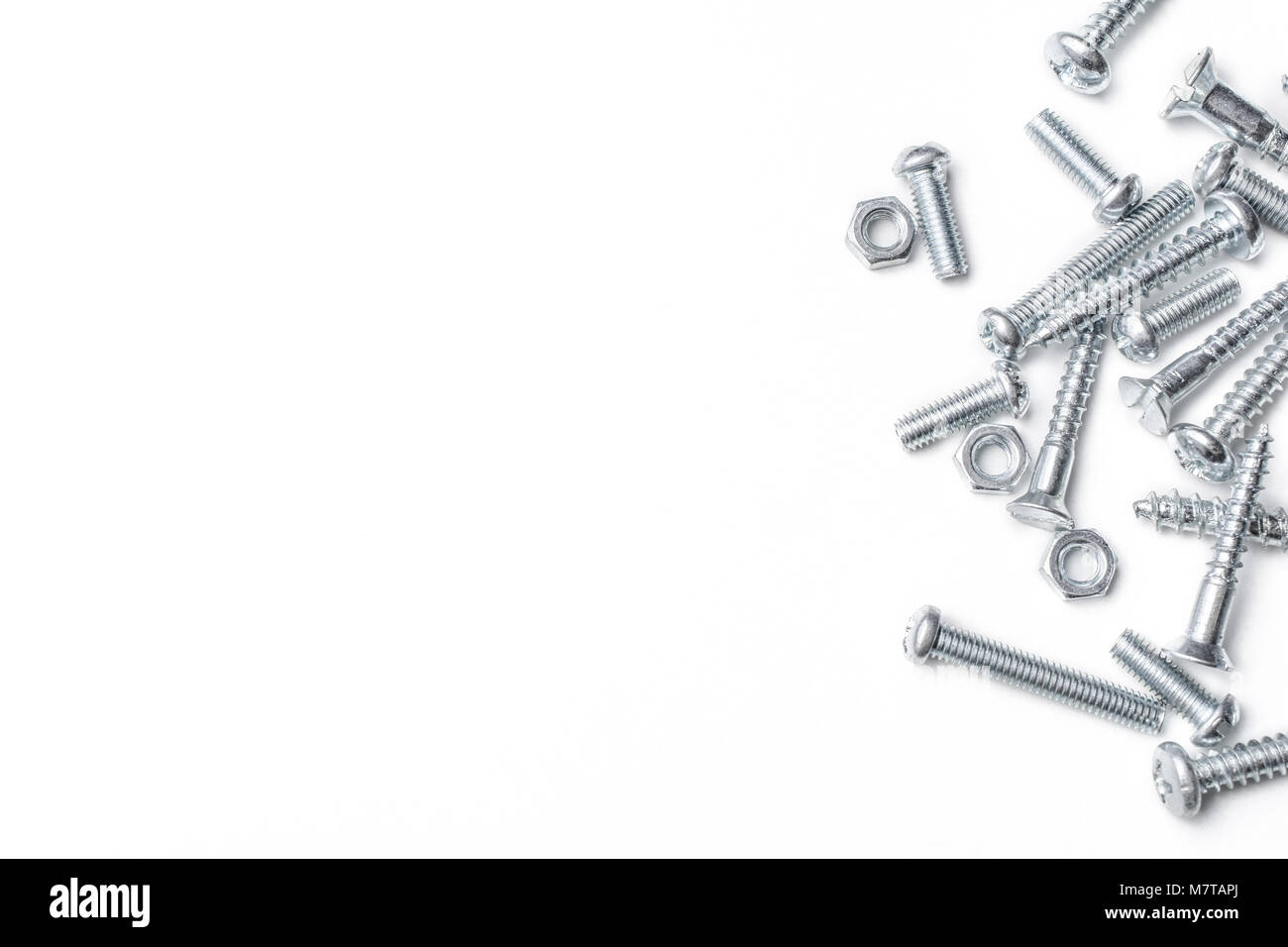 Collection Of Iron Screws And Bolts At The Right Edge Of A Whitebox Stock Photo