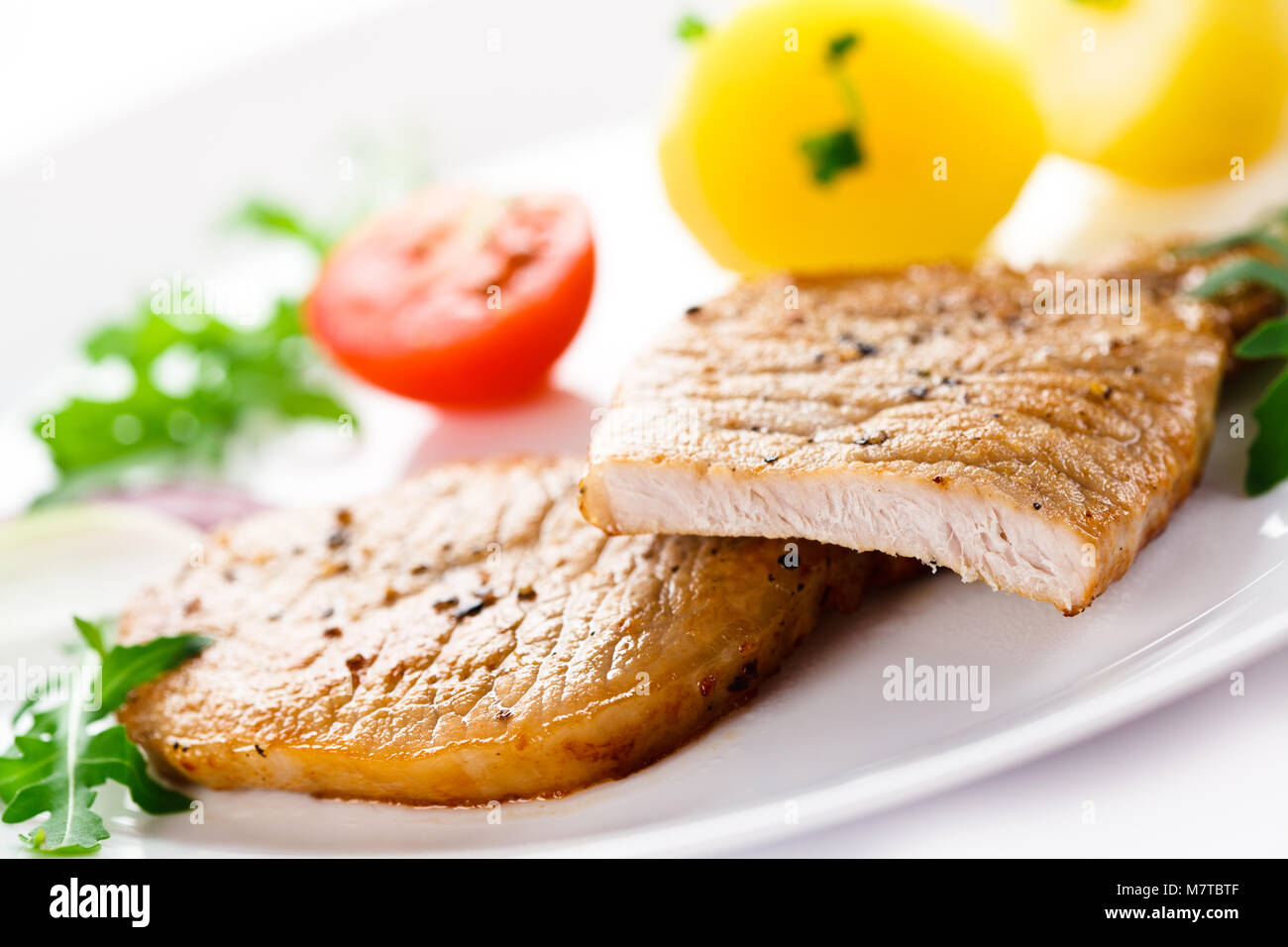 Grilled steaks, boiled potatoes and vegetable salad Stock Photo - Alamy