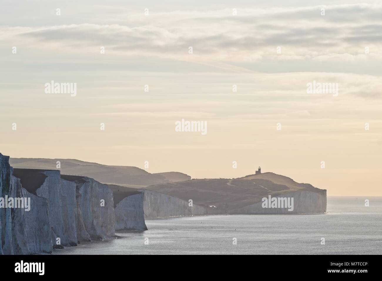 Chalk cliffs at Seven Sisters Country Park with lighthouse in distance Stock Photo