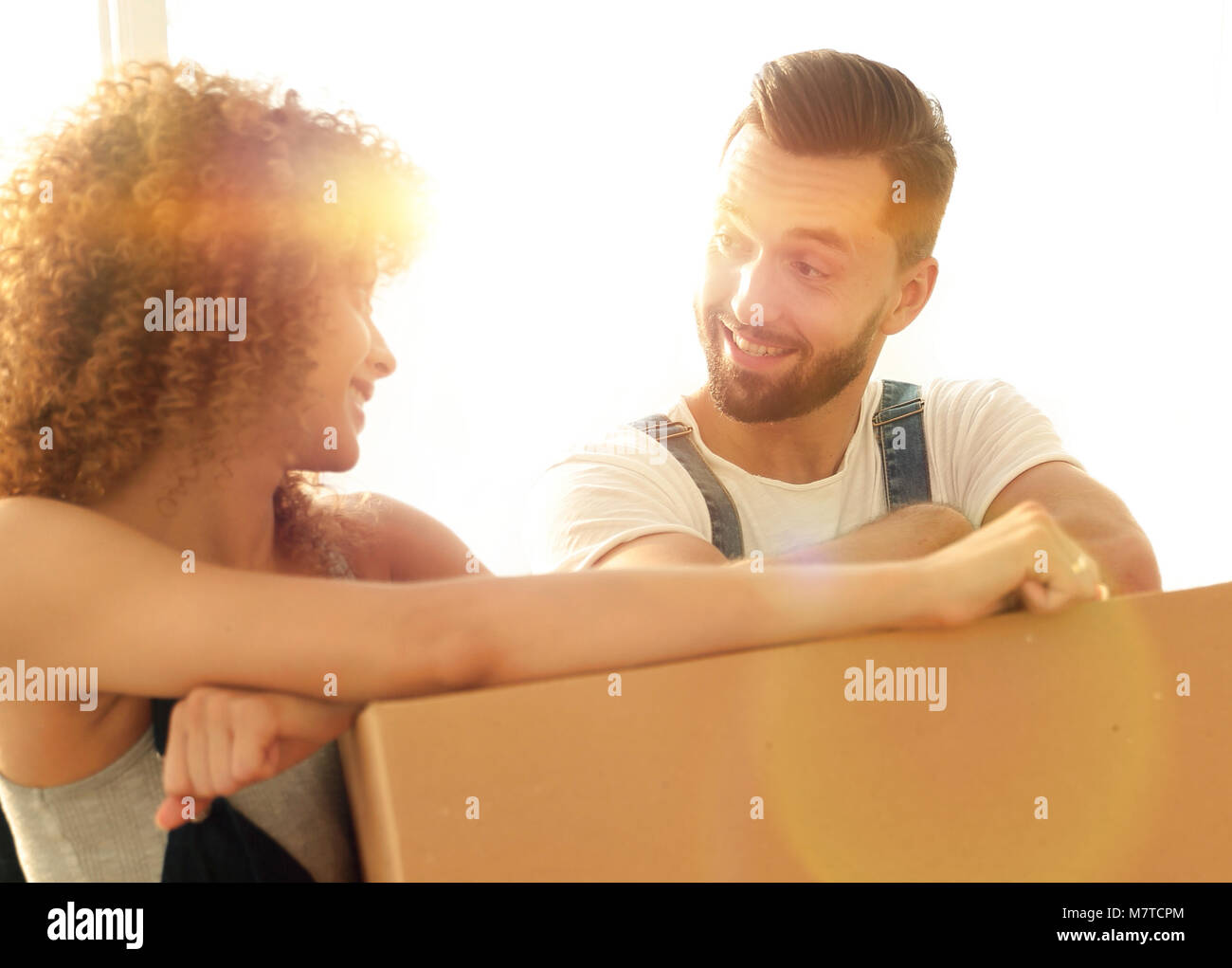 Happy couple honeymooners standing near boxes Stock Photo