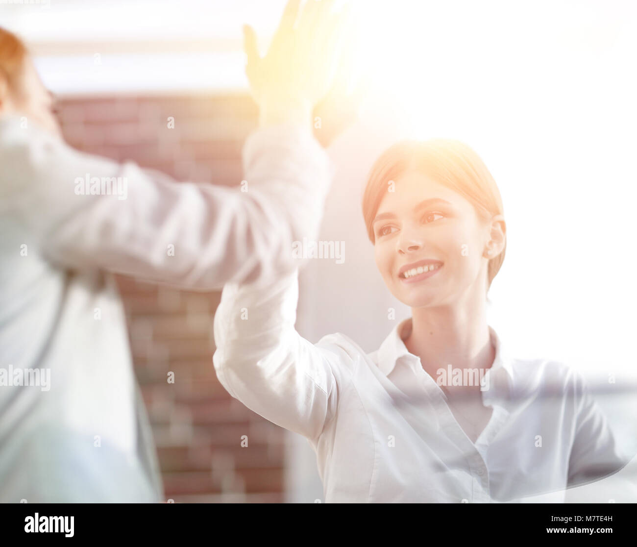 members of the business team giving each other a high five Stock Photo ...