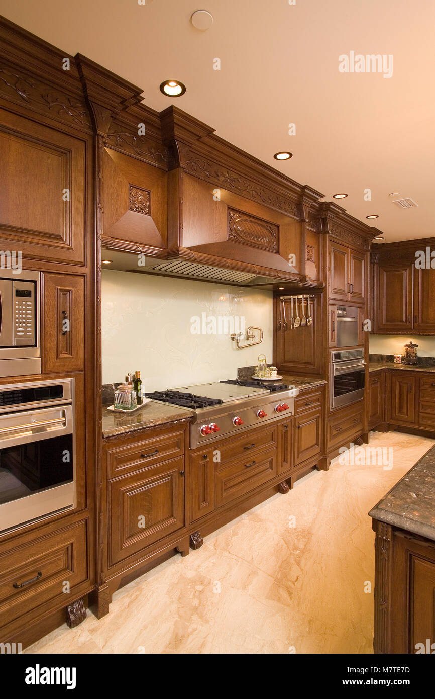 High End Brown Wooden Kitchen With Granite Counter Top And Marble
