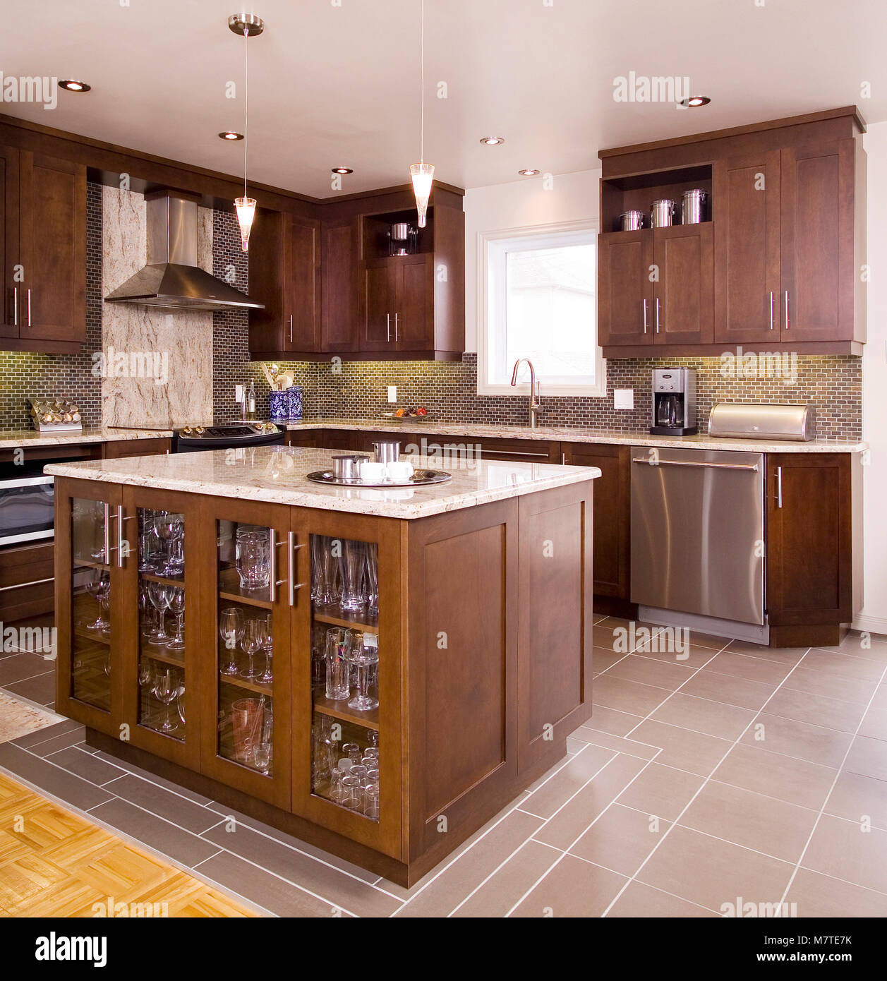 Brown wooden kitchen with island with a granite counter top Stock Photo