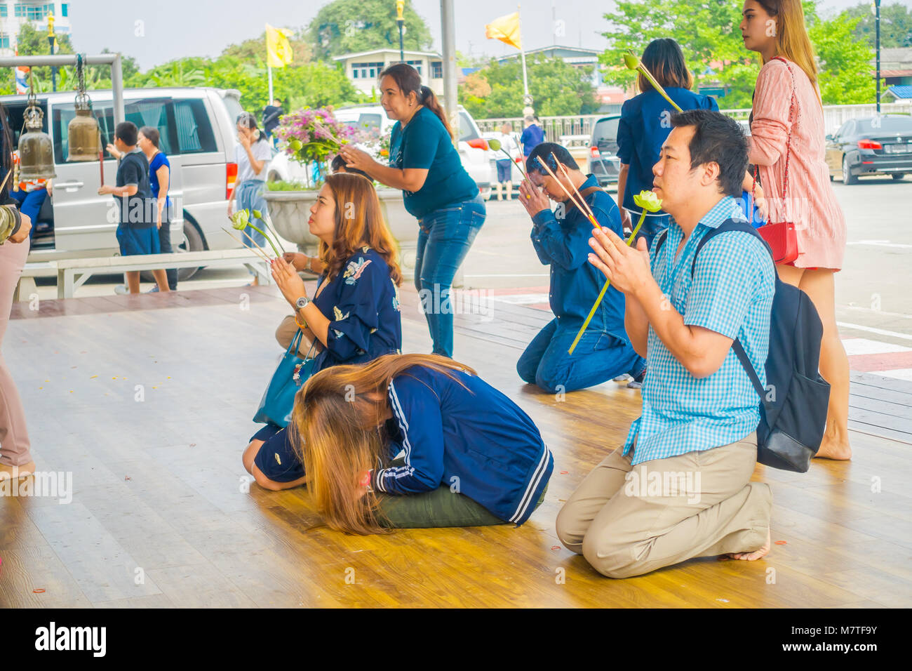 AYUTTHAYA, THAILAND, FEBRUARY, 08, 2018: Outdoor view of unidentified people praying on their knees inside of a temple at Wat Lokayasutharam in Ayutthaya Stock Photo