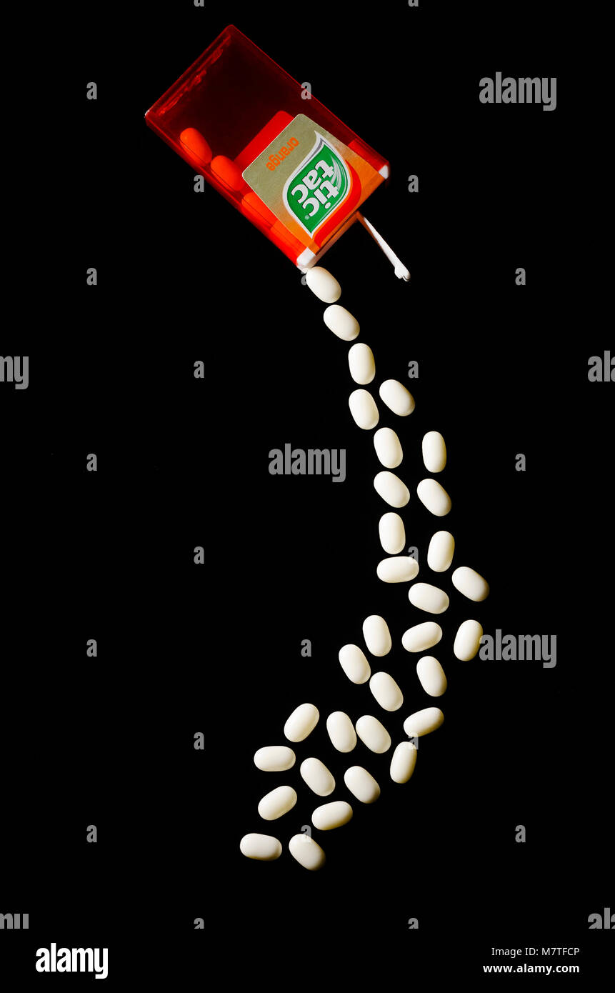 Falling tic tacs isolated on dark background. Tic tacs are manufactured by  Italian confectioner Ferrero and were first produced in 1968 Stock Photo -  Alamy