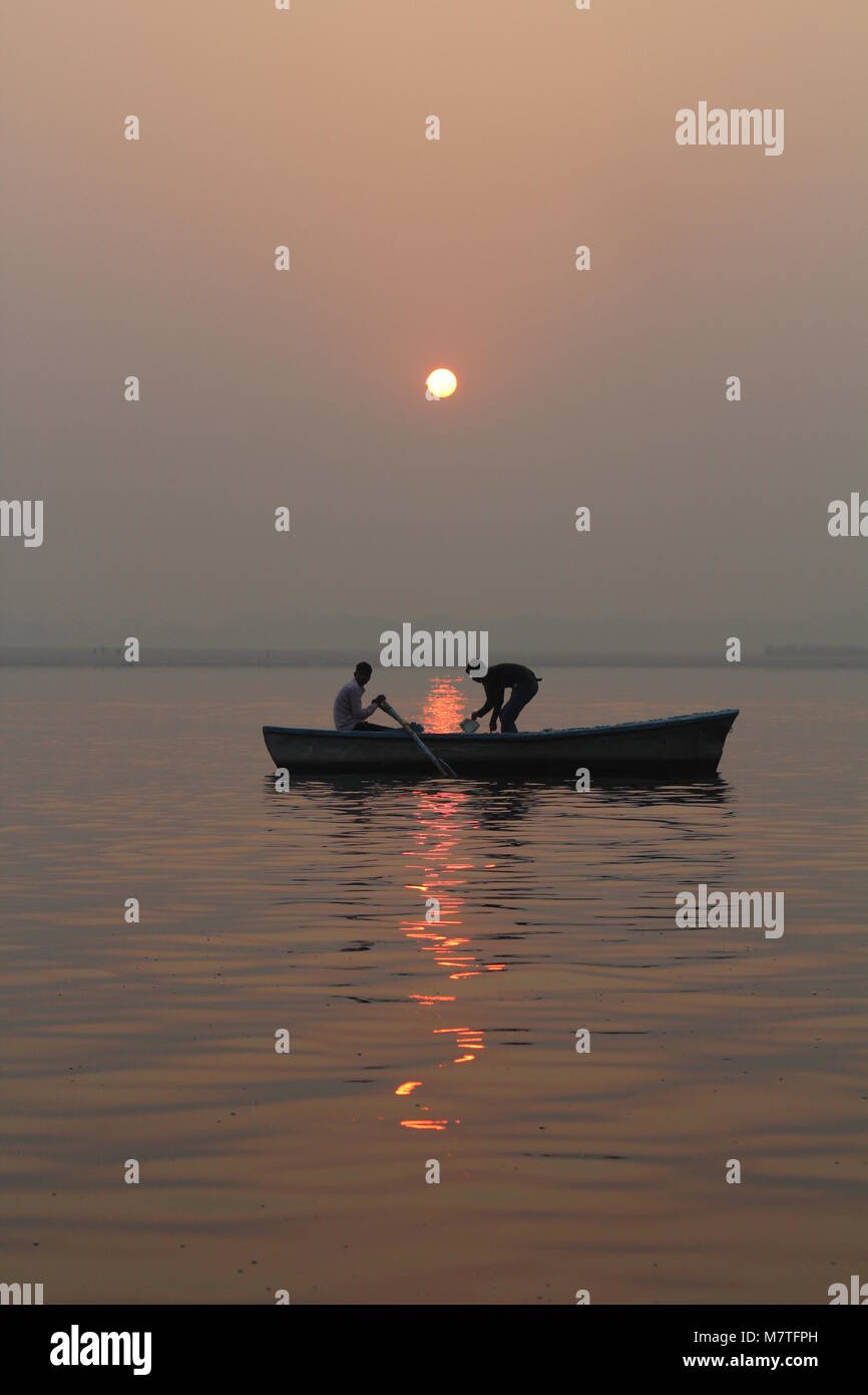 Sunset in the river with boats and people Stock Photo - Alamy