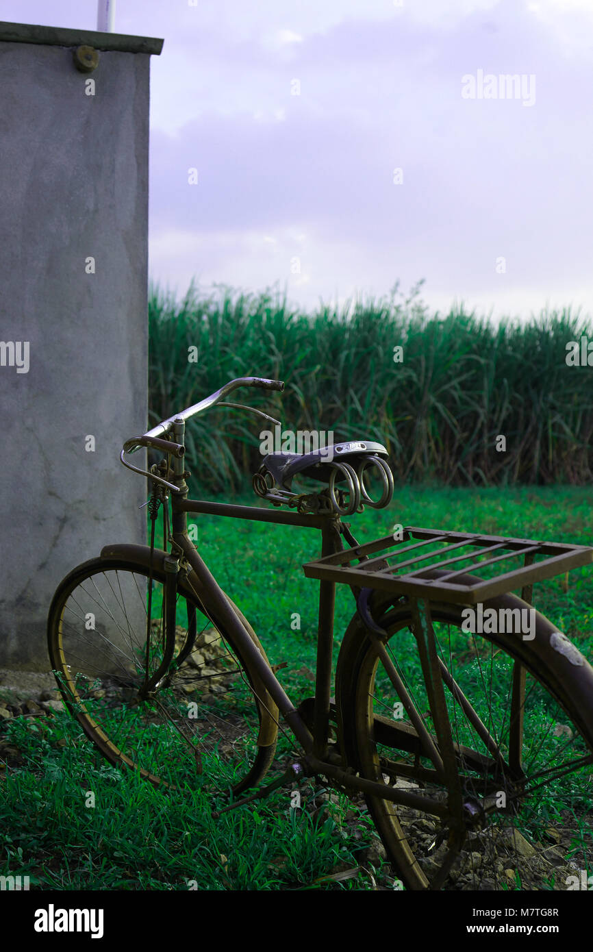 An old bicycle in a farmland Stock Photo