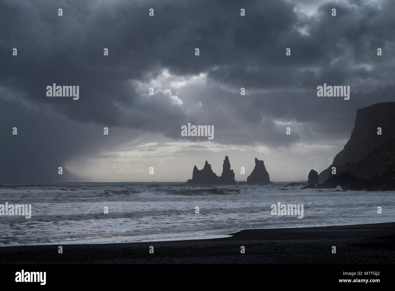 Reynisfjara black sand beach and Reynisdrangar basalt sea stacks as ...