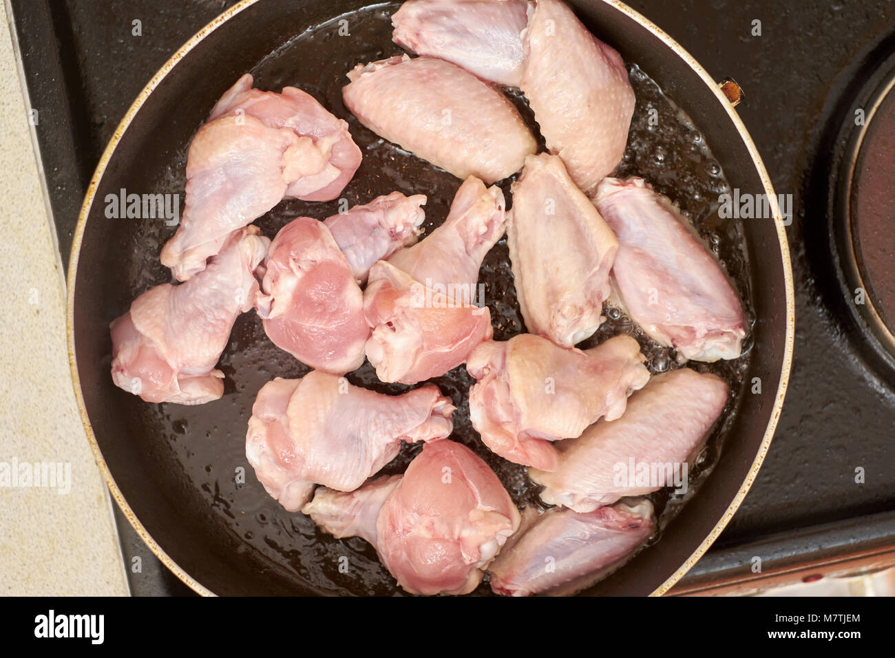 chicken wings frying with oil on a hot pan Stock Photo Alamy
