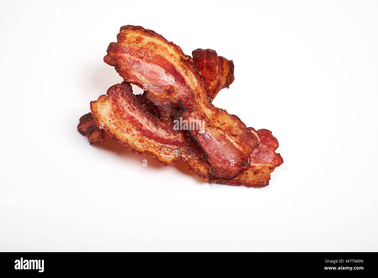 crispy fried bacon isolated on a white background. Stock Photo
