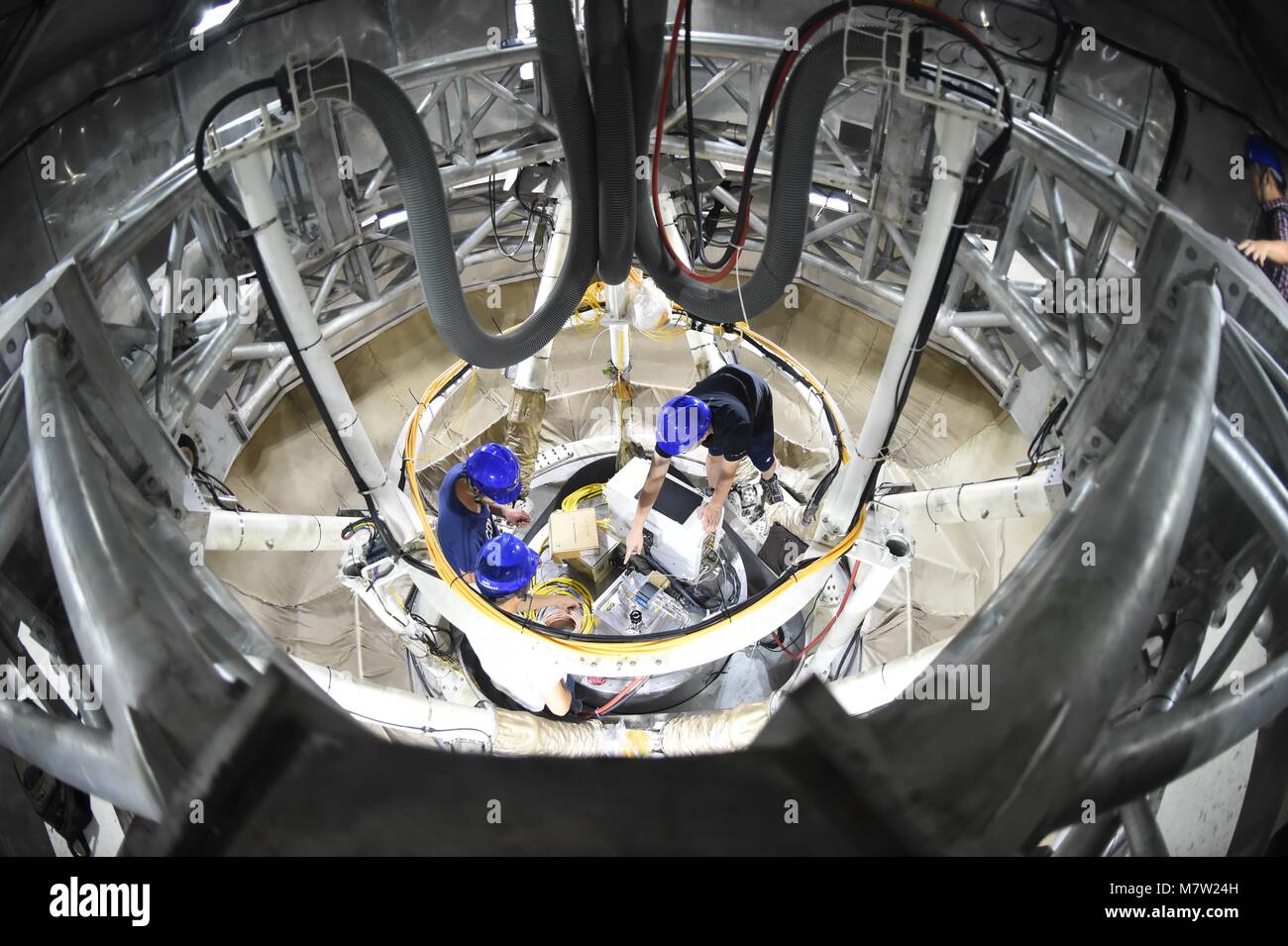 (180313) -- GUIYANG, March 13, 2018 (Xinhua) -- File photo taken on Aug. 10, 2017, shows staff members working in the feed cabin of the Five-hundred-meter Aperture Spherical Radio Telescope (FAST) in Pingtang County, southwest China's Guizhou Province. China's FAST, the world's largest single-dish radio telescope, has discovered 11 new pulsars so far, the National Astronomical Observatories of China (NAOC) said Tuesday. (Xinhua/Ou Dongqu)(wsw) Stock Photo