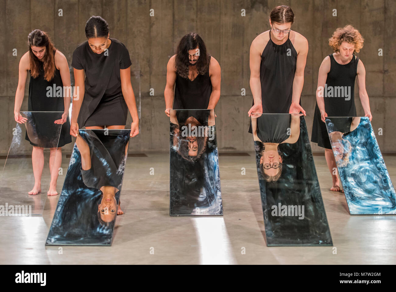 London, UK. 13th March, 2018. Mirror Piece II, an early work in which a group of performers make choreographed movements while holding tall; narrow mirrors - Joan Jonas, Tate Modern opens largest survey of pioneering performance artist’s work from her five decade career. It includes an immersive gallery exhibition and live performance programme. Credit: Guy Bell/Alamy Live News Stock Photo