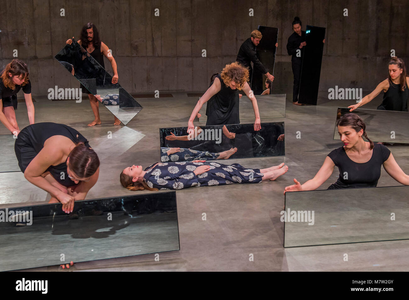 London, UK. 13th March, 2018. Mirror Piece II, an early work in which a group of performers make choreographed movements while holding tall; narrow mirrors - Joan Jonas, Tate Modern opens largest survey of pioneering performance artist’s work from her five decade career. It includes an immersive gallery exhibition and live performance programme. Credit: Guy Bell/Alamy Live News Stock Photo