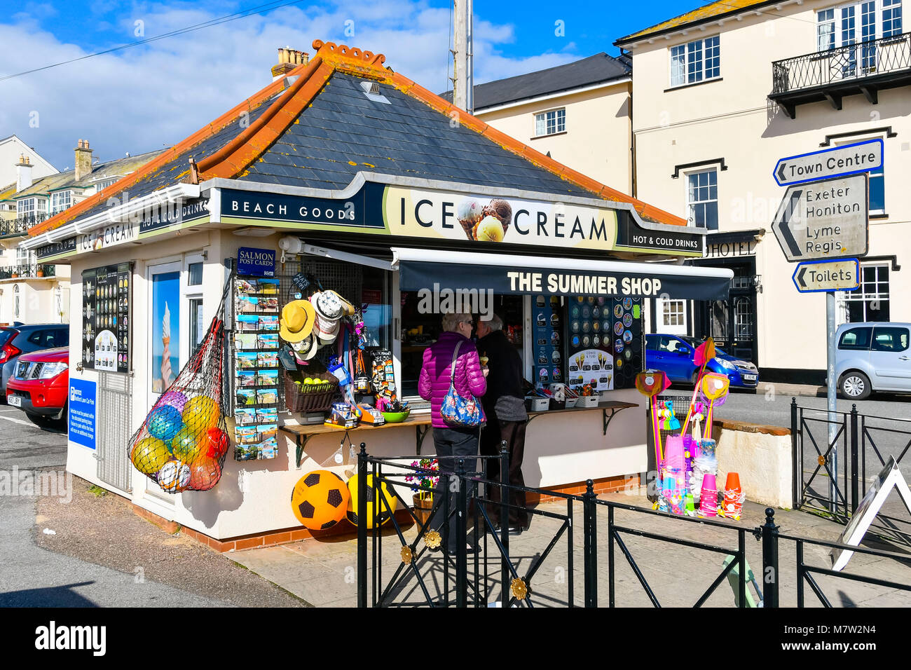 Sidmouth, Devon, UK.  13th March 2018.  UK Weather.  A couple buying an ice cream from The Summer Shop kiosk at the seaside town of Sidmouth in Devon on a warm sunny spring afternoon.  Picture Credit: Graham Hunt/Alamy Live News. Stock Photo