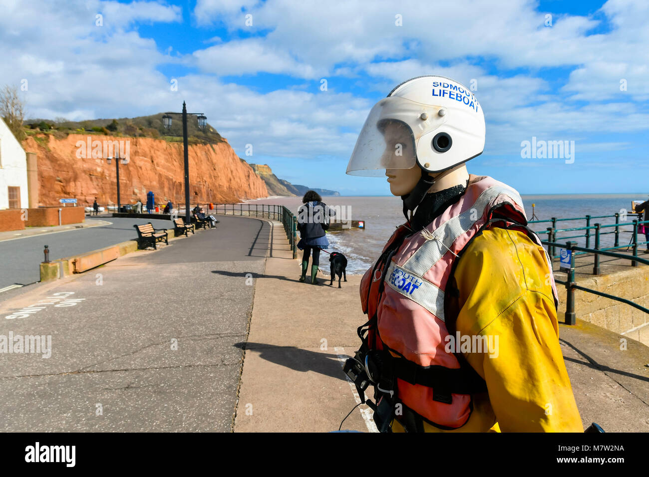 Sidmouth, Devon, UK.  13th March 2018.  UK Weather.  The Sidmouth RNLI lifeboat mannequin in rescue gear on the seafront at the seaside town of Sidmouth in Devon on a warm sunny spring afternoon.  Picture Credit: Graham Hunt/Alamy Live News. Stock Photo