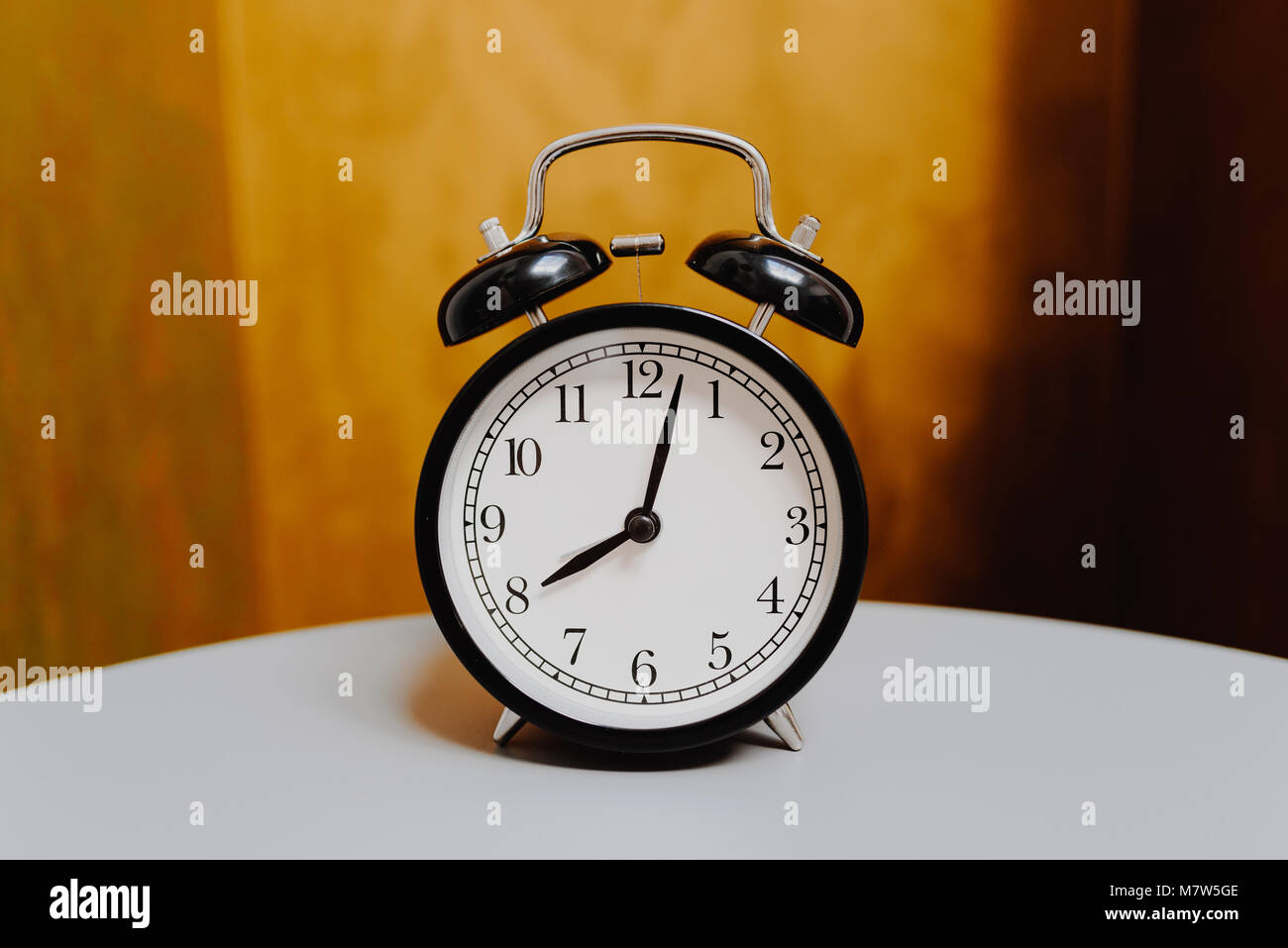 black retro alarm clock on vintage color background Stock Photo - Alamy
