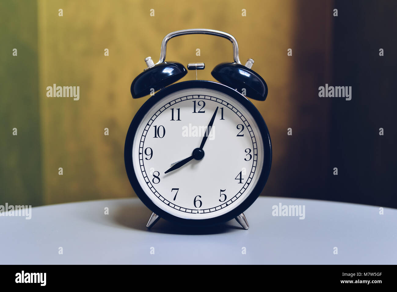 Retro alarm clock on table with vintage color background Stock Photo ...