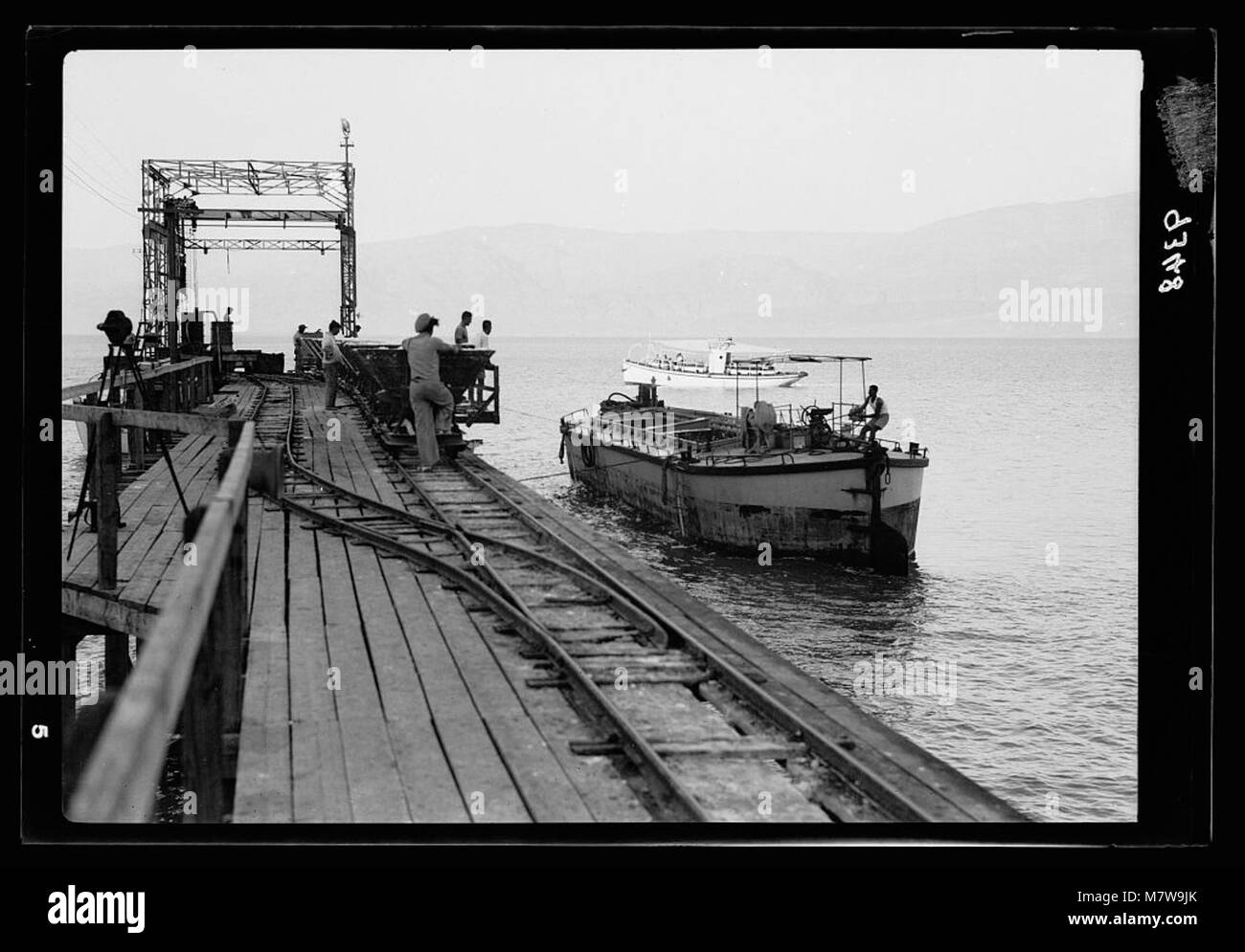 Dead Sea Album, prepared for the Palestine Potash Ltd. The one hundred ton barge being pulled up to the Usdum pier to be loaded with potash for the North LOC matpc.18293 Stock Photo