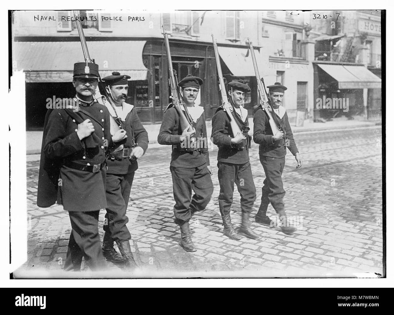 A photo capturing naval recruits engaged in police duties in Paris, showcasing a historical moment of military and law enforcement collaboration during the early 20th century. Stock Photo