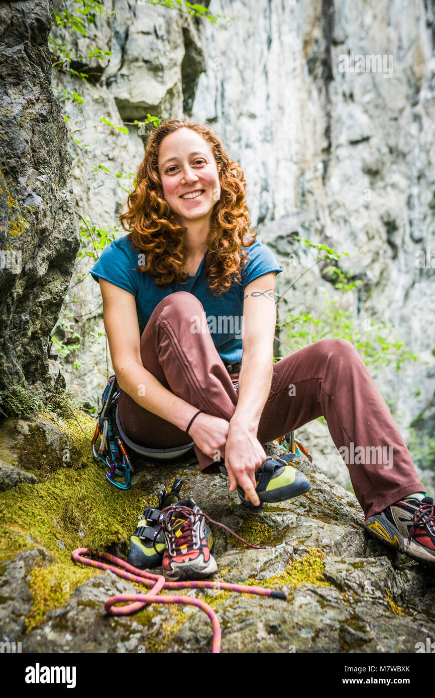Woman putting climbing harness hi-res stock photography and images - Alamy