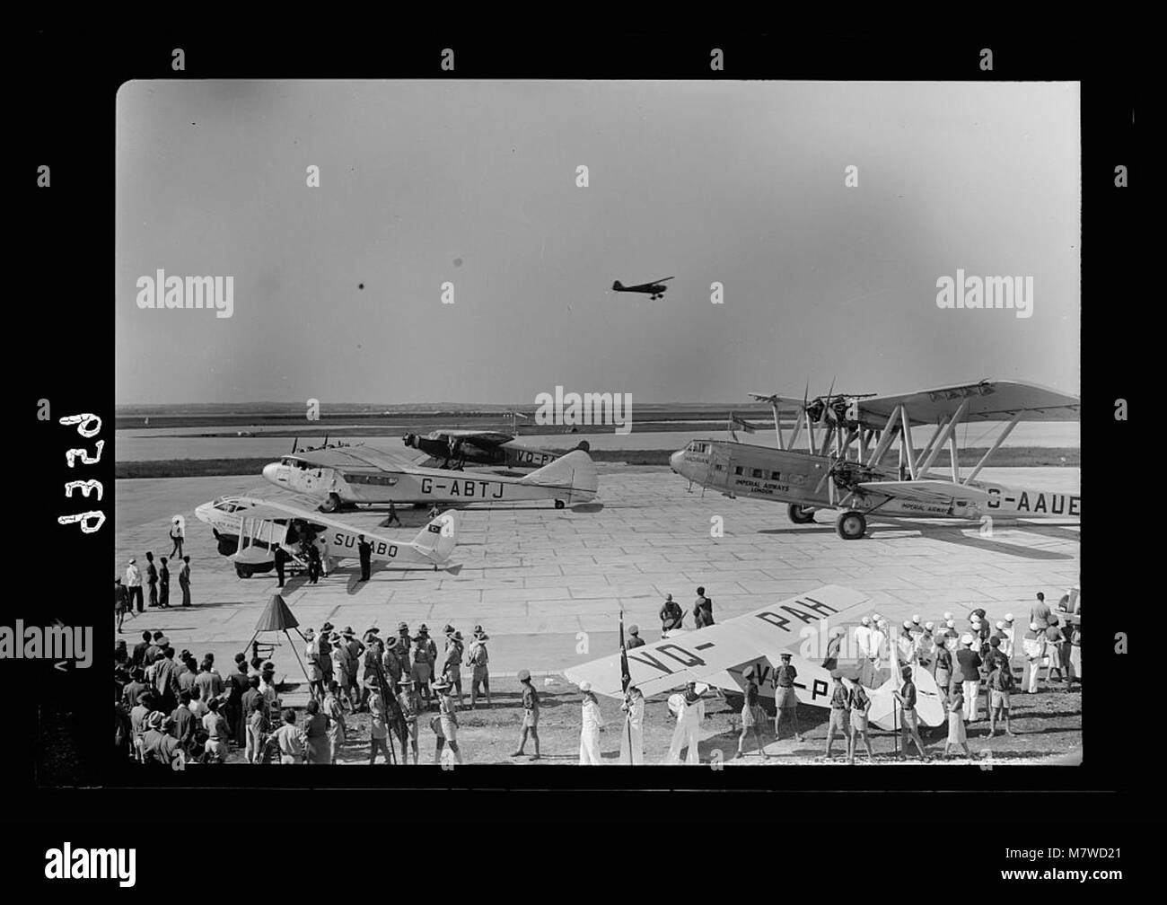 This photograph shows a historical moment from Lydda Airport in Palestine on April 21, 1939. It features airliners and a test plane taking off, marking the development of aviation in the region and the role of flying schools. Stock Photo