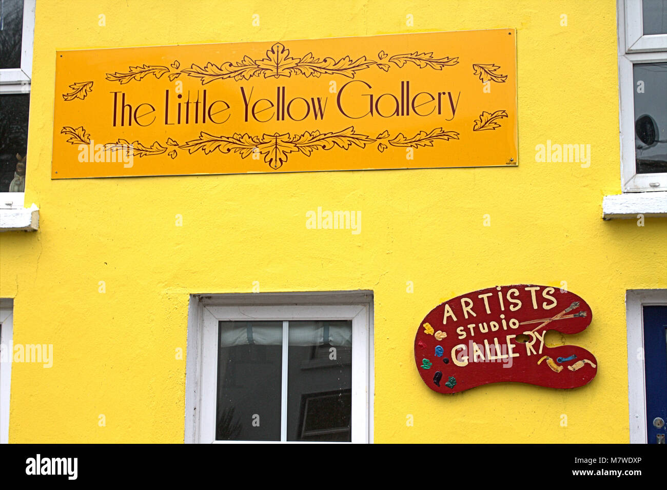 A small artists gallery in Union Hall, West Cork, Ireland. Painted bright yellow on the outside. Stock Photo
